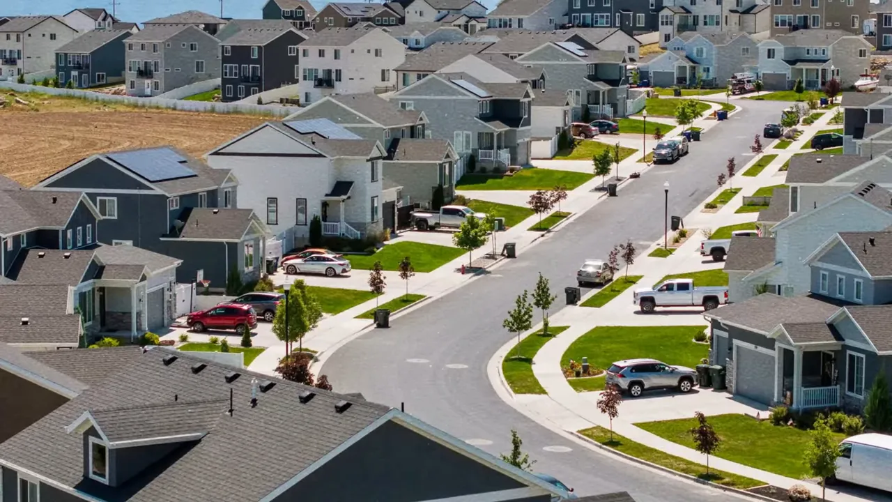new suburban neighborhood street with modern homes and driveways