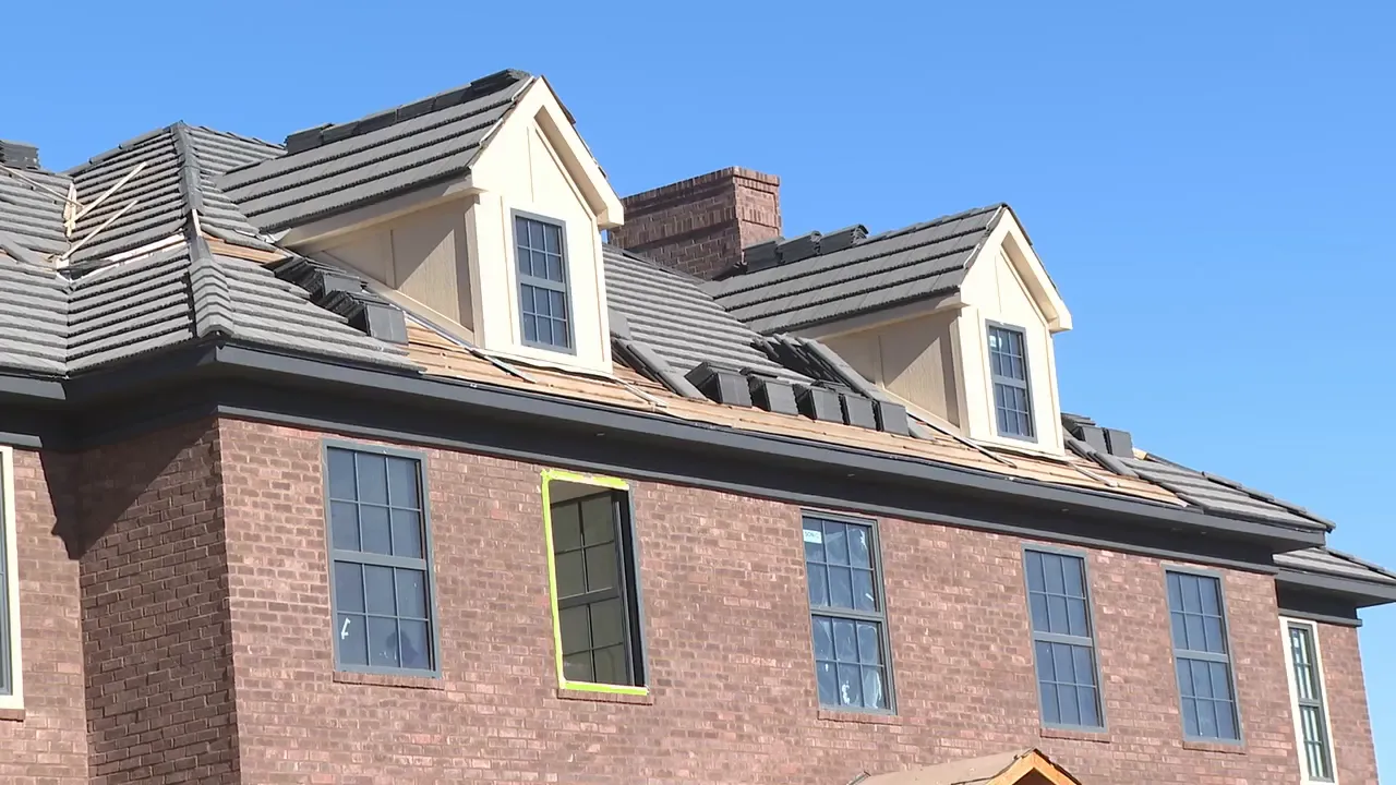 Close view of dormer windows and brick exterior of the Georgian‑style house recreation.